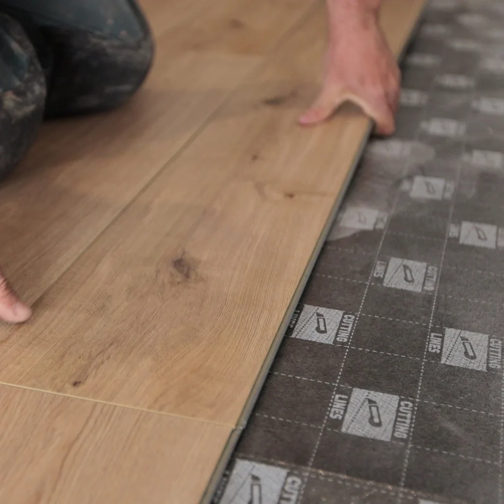 Flooring plank being installed in a residential room